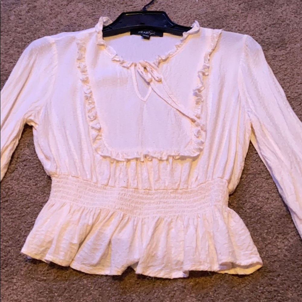 A ruffled white long sleeved shirt
